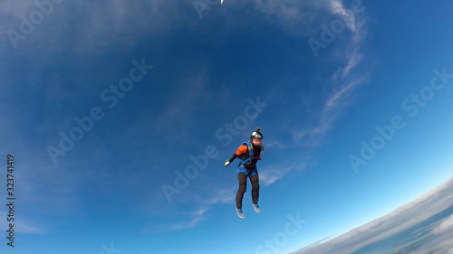 Fitness. Skydiver engaged in air fitness. Man soars in the sky like a bird. Team of professionals.