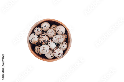 Quail eggs are isolated in wooden basket on a white background. Easter concept, flay lay photo. Mockup, space for text.