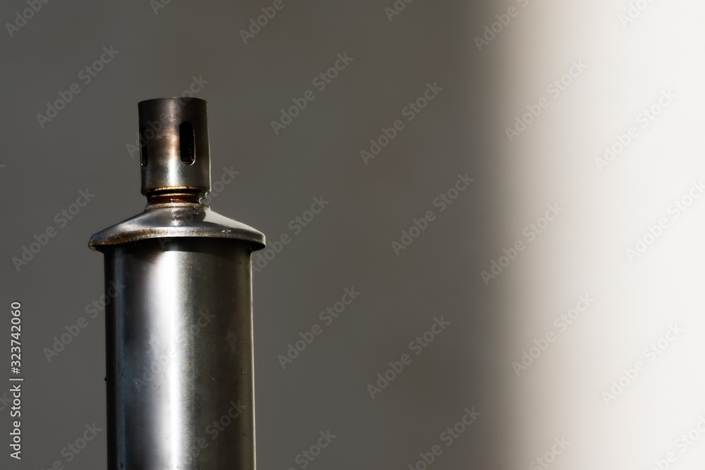 Metal petrol garden torch in close up with copy space Metal petrol garden torch in close up with copy space