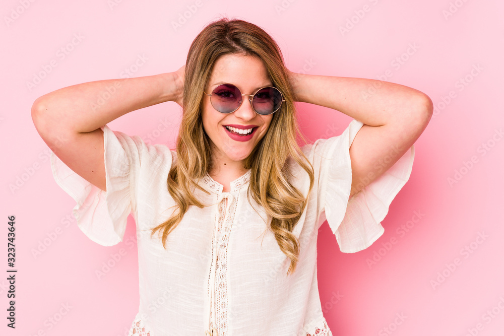 Young caucian woman with glasses isolated on pink background screaming, very excited, passionate, satisfied with something. Young caucian woman with glasses isolated on pink background screaming, very excited, passionate, satisfied with something.