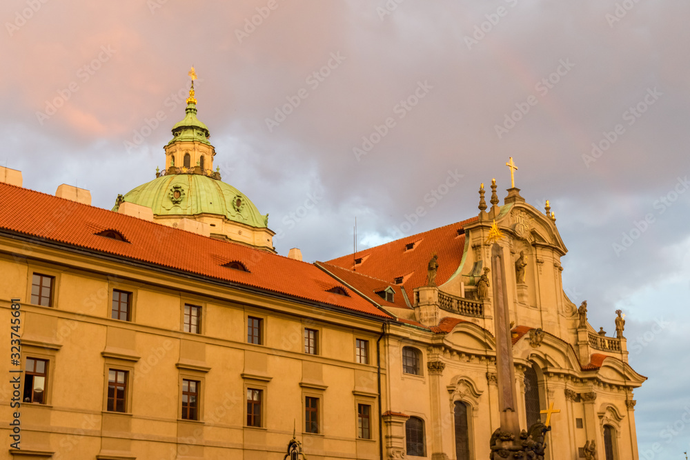View of the top of old buildings with red roof and dramatic pink sky at Prague city Czech republic.
