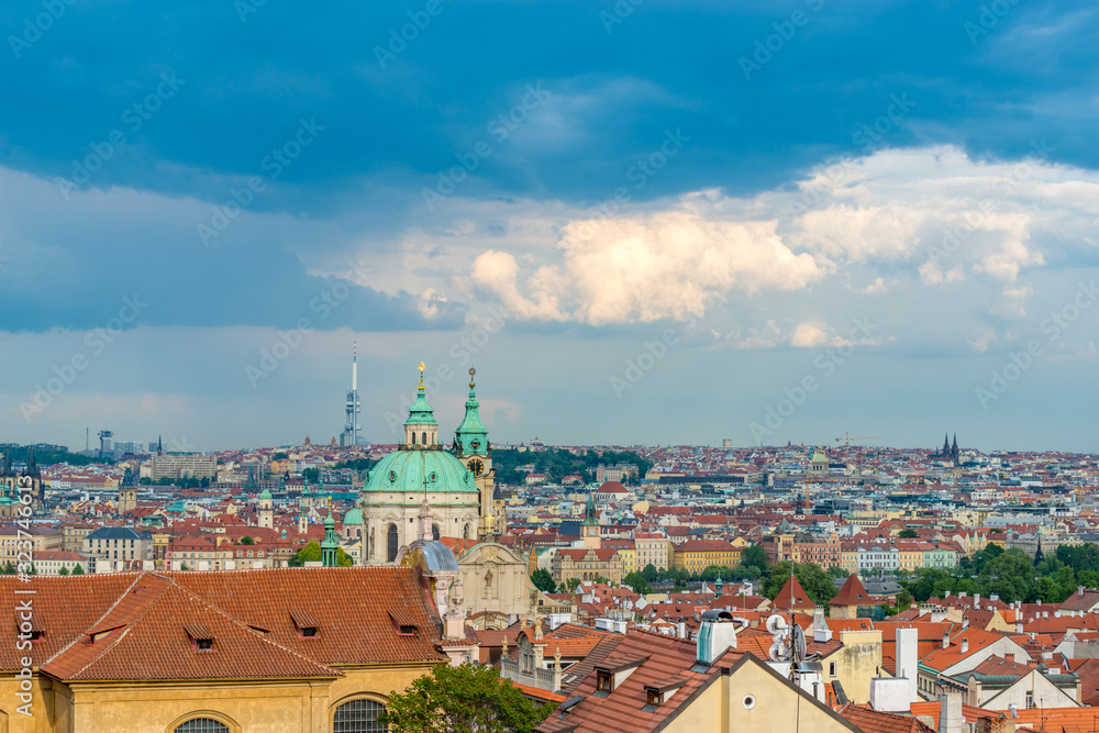 Top view to red roofs and dramatic sky of Prague city Czech republic.