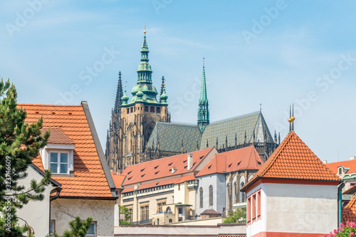 Wallpaper Mural Top view to red roofs and green trees skyline of Prague city Czech republic. Torontodigital.ca