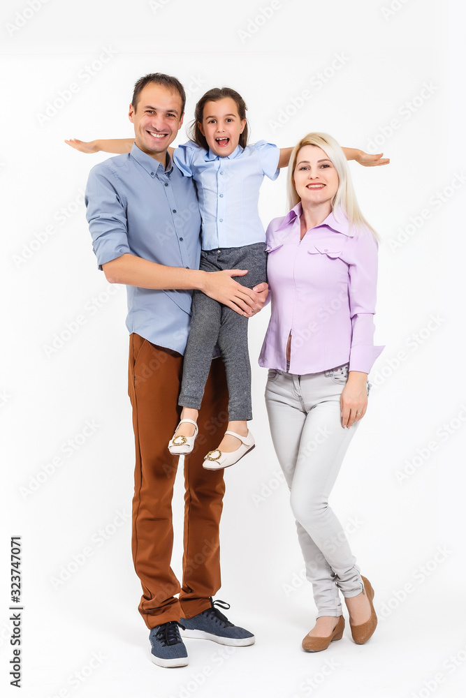 Fototapeta premium Happy young family with pretty child posing on white background