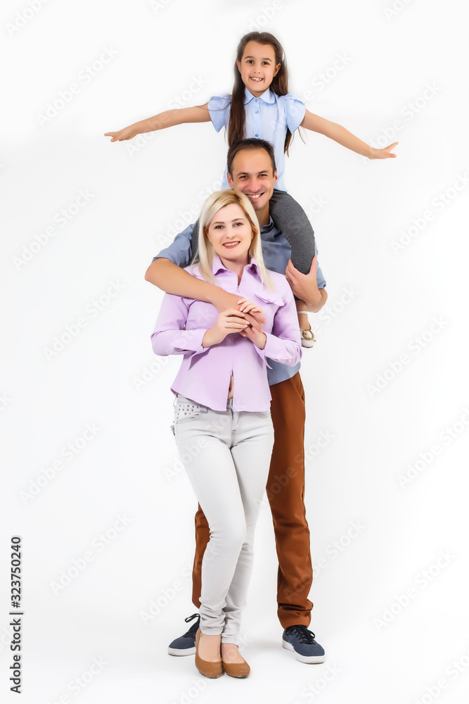 Happy young family with pretty child posing on white background