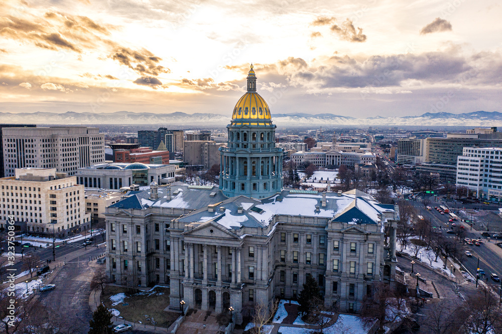 Colorado State Capitol Building & the City of Denver Colorado at Sunset. Rocky Mountains on the Horizon