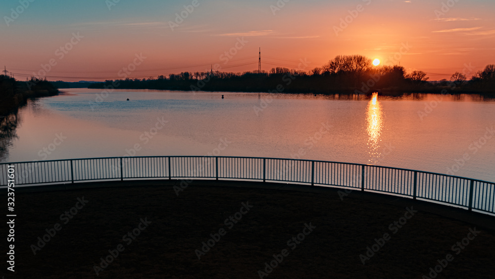 Fototapeta premium Beautiful sunset with reflections at Plattling, Isar, Bavaria, Germany