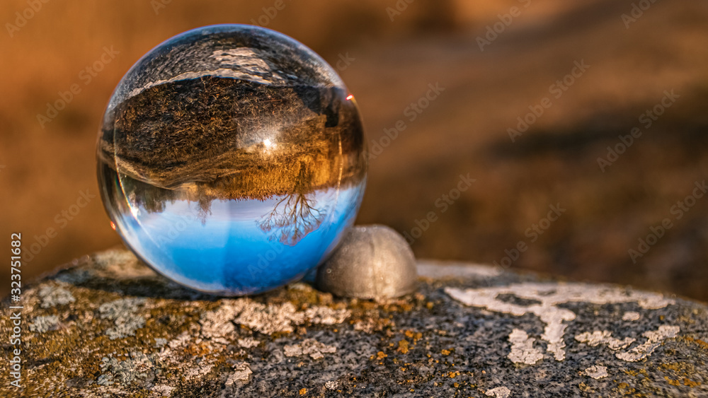 Crystal ball landscape shot on a landmark stone at Niederpöring, Isar, Bavaria, Germany Crystal ball landscape shot on a landmark stone at Niederpöring, Isar, Bavaria, Germany