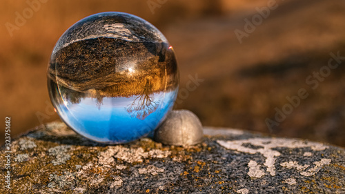 Crystal ball landscape shot on a landmark stone at Niederpöring, Isar, Bavaria, Germany