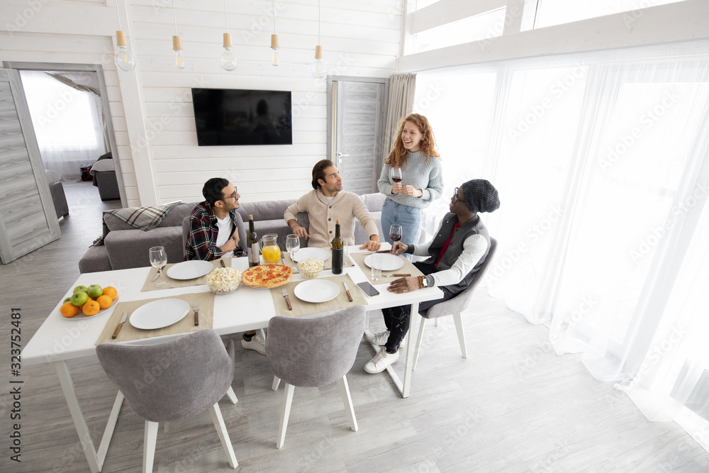 Group of young multi-ethnic friends gathering together to drink wine at home Group of young multi-ethnic friends gathering together to drink wine at home