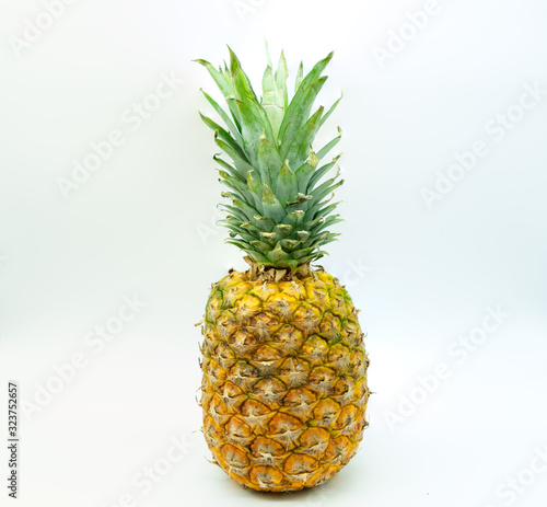 Isolated pineapple on a white background in the center of the image. Healthy food concept.