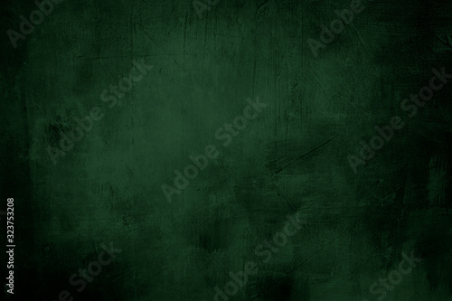 Fotografija green grunge background or texture with dark vignette borders and spotlight