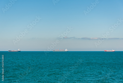 Three ships on the black sea horizon © sergograph