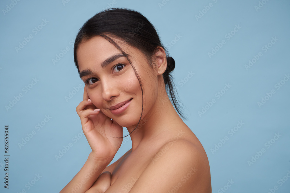 Portrait of a young girl with natural makeup with clean skin on a blue background Portrait of a young girl with natural makeup with clean skin on a blue background