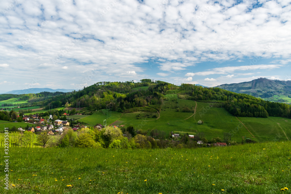 surrounding of Palkovice village with Myslik settlement, hills, meadows and blue sky with clouds in Czech republic