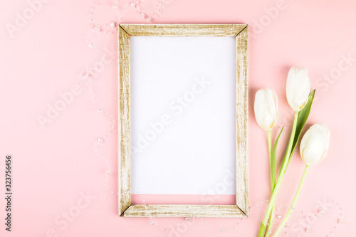 Festive composition on a pink paper background. Photo frame a traditional decoration © lily_rocha