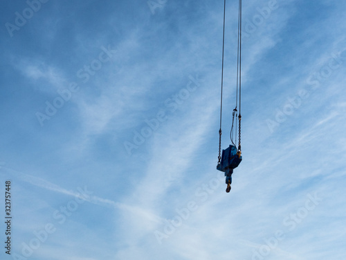crane hook seen from below with blue sky background