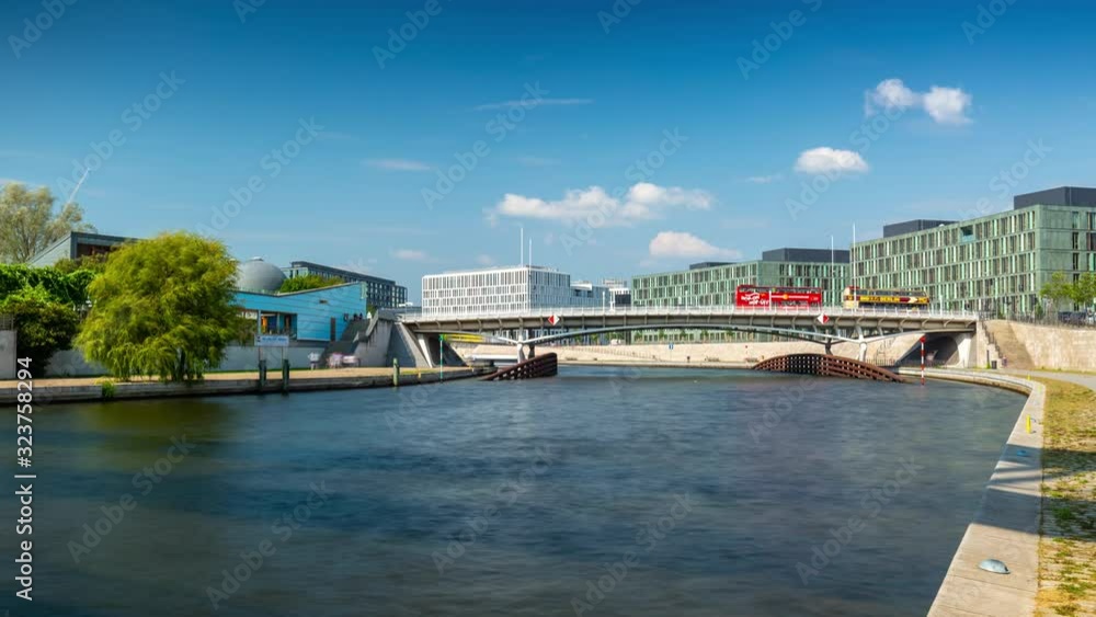 BERLIN, GERMANY - MAY,2019: Timelapse view of a bridge over Spree River, with boats in the city centre near Bundestag.