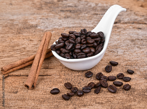 Coffee beans and cinnamon on old wood background