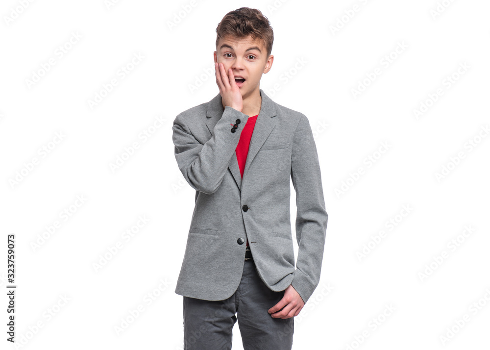 Emotional portrait of caucasian teen boy, isolated on white background. Funny child teenager looking at camera and shocked. Handsome surprised boy in gray suit. Emotional portrait of caucasian teen boy, isolated on white background. Funny child teenager looking at camera and shocked. Handsome surprised boy in gray suit.
