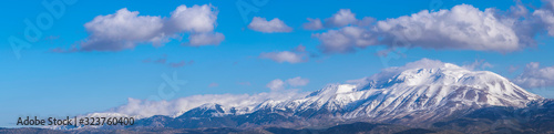 Snowy mountain wide panoramic view with cloudy sky. Davraz Mountain in Isparta / Turkey.