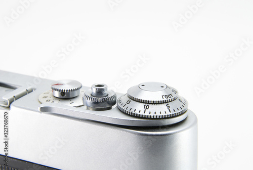 Old film retro camera. Shutter and trigger (button) close-up. Metallic black. White isolated background.
