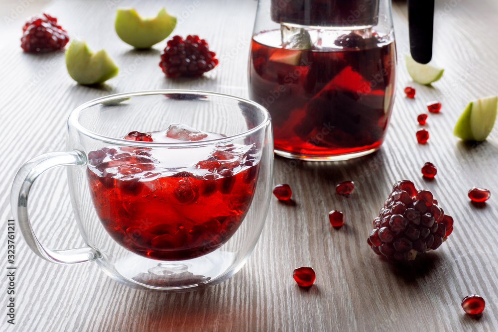 thermal glass cup with ice and pomegranate tea with apple thermal glass cup with ice and pomegranate tea with apple