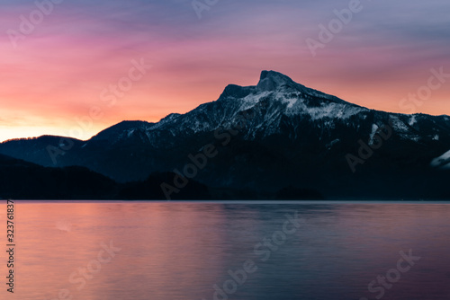 sunrise at the lake on a pier with panorama view to the mountains © Dominik