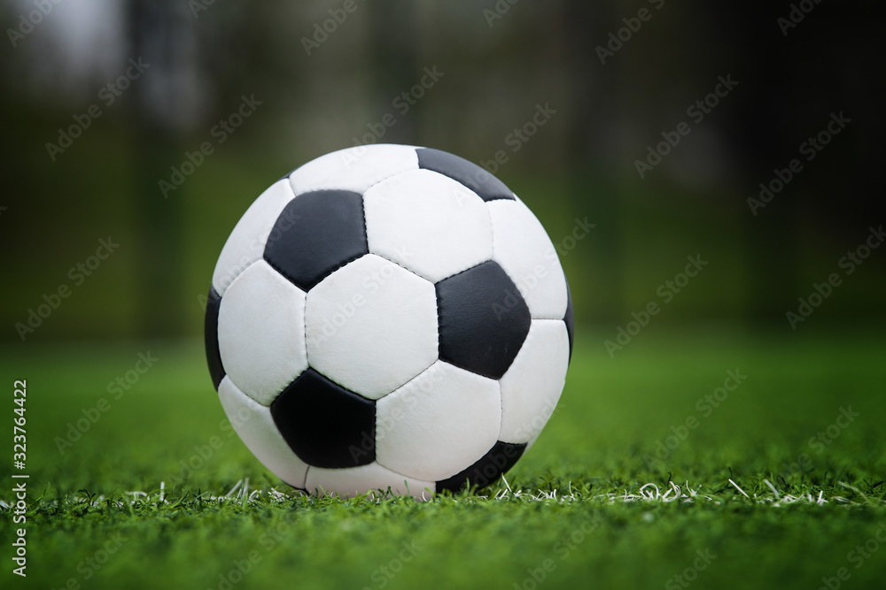 Fototapeta premium Closeup soccer ball in green grass on stadium