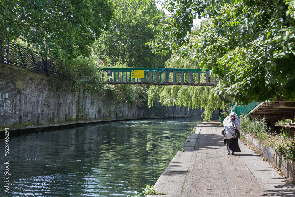 Canal, Bridge and Pedestrian Path along the River Bank of Regent’s Canal in London Canal, Bridge and Pedestrian Path along the River Bank of Regent’s Canal in London