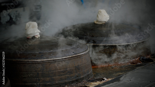 Traditional iron cooking pot boiling food at Korean restaurant