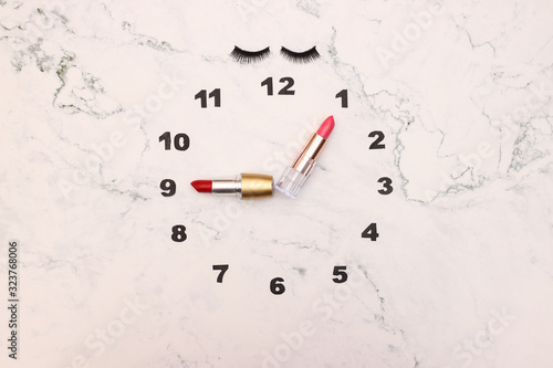 Creative clock made of make up and cosmetics products with lipstick clock wise 