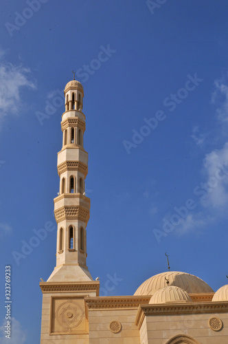 Minarett of mosque with blue sky in Dubai