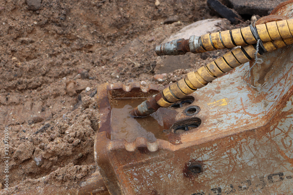 Thick wire of a construction mechanism near the water. Electricity and water. Thick wire of a construction mechanism near the water. Electricity and water.
