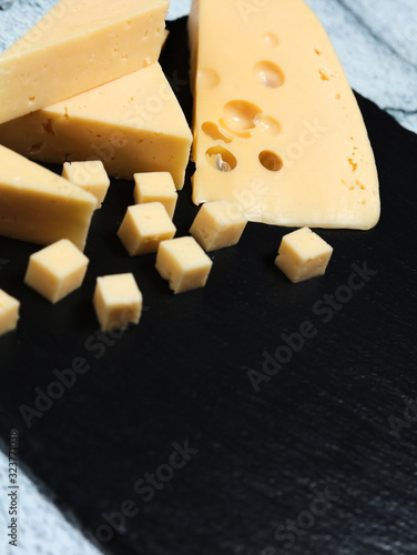 Pieces of cheese on a dark background.