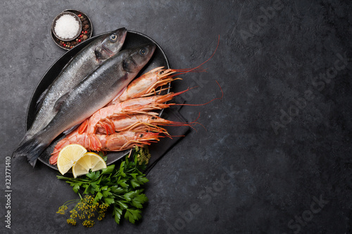 Fresh seafood. Trout fish and langostino shrimps photo