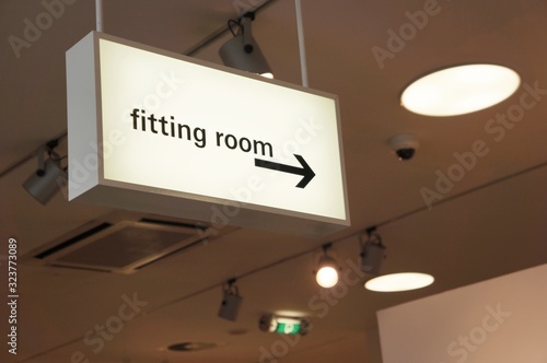 Vászonkép Closeup shot of the fitting room signage hanging from a ceiling in a clothing st