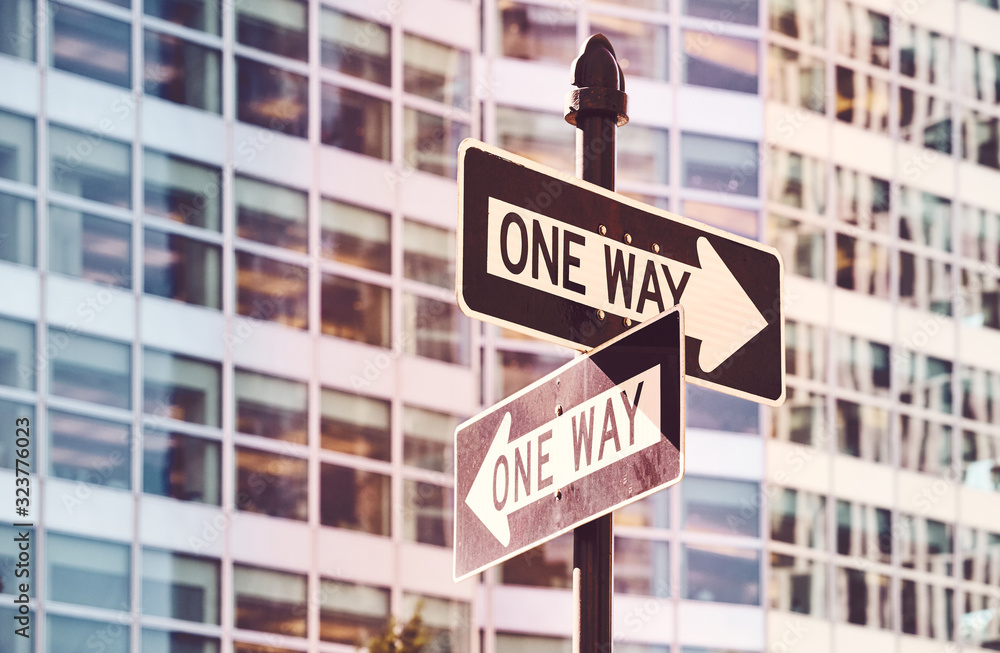 Retro toned picture of one way street signs in New York City, selective focus, USA. Retro toned picture of one way street signs in New York City, selective focus, USA.