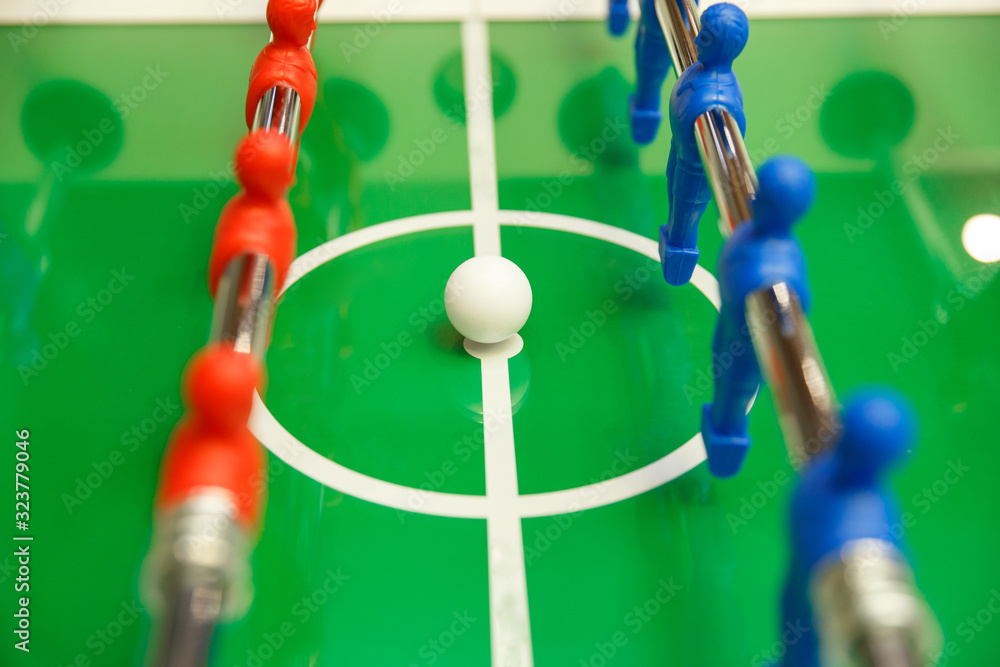 Foosball ball on table football table with figures Foosball ball on table football table with figures