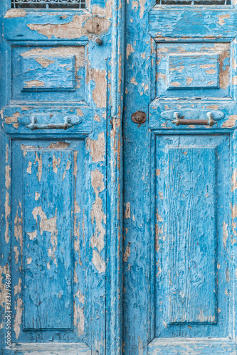 a blue wooden door is a peeling color © berna_namoglu
