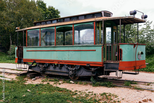 Old train passengers wagon abandoned on rails.