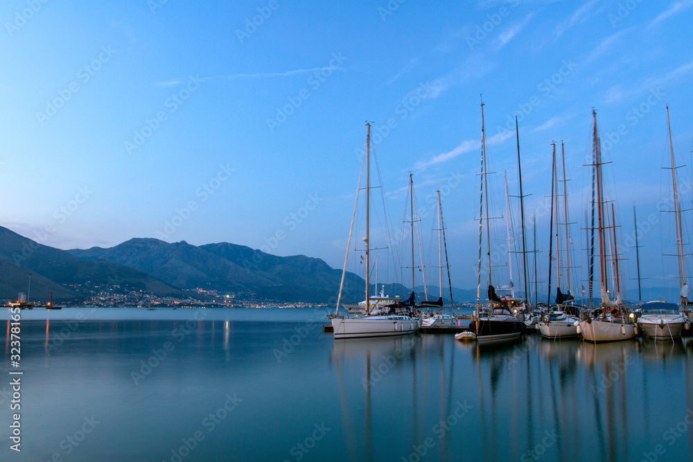 View of sailing yachts in the Mediterranean in beautiful evening light, a summer cruise. Gaeta, Italy.
