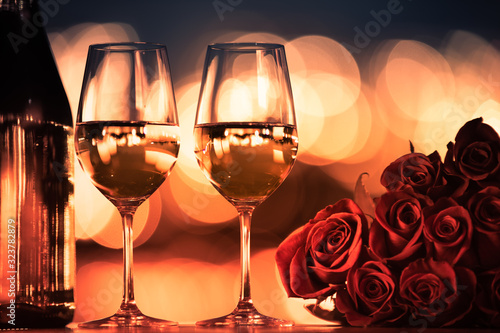 Wine and roses on table in a beautiful romantic date night setting. 
