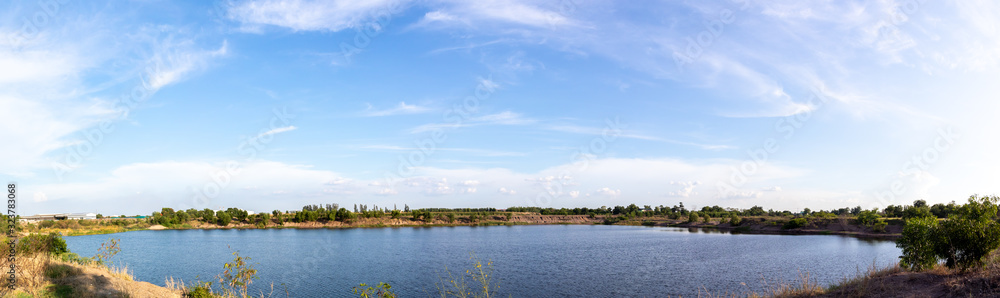 Panorama of blue sky with clouds, Sky background image, Natural pool at bottom of picture.