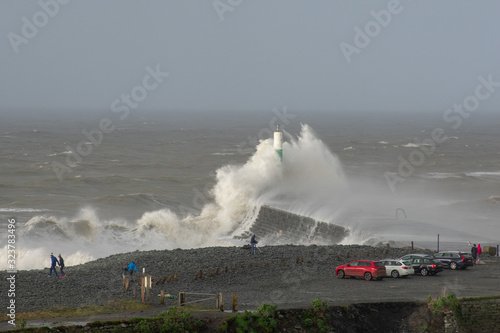 Tableau sur toile Storm Dennis creates big waves that crash into the seaside town of Aberystwyth , Wales