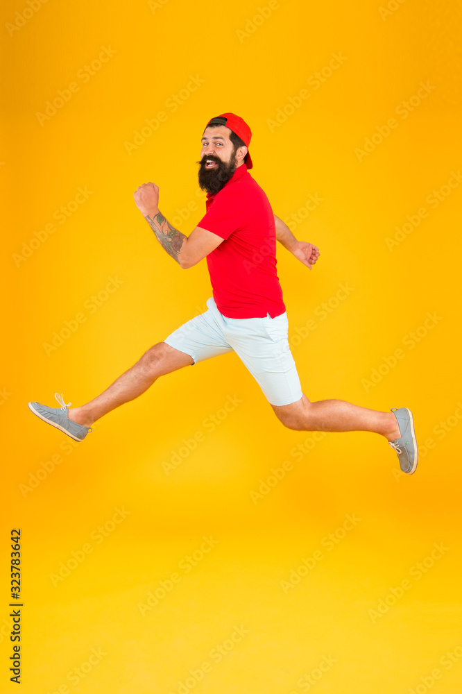 jumping up in air. having fun time rejoicing. Like a rock star. hipster celebrating success. Keep moving. Run hard. hurry up man is fast. rush hour. Last chance. bearded man run away