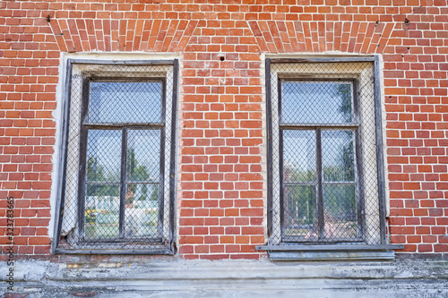 The windows of the old palace with a metal mesh for security