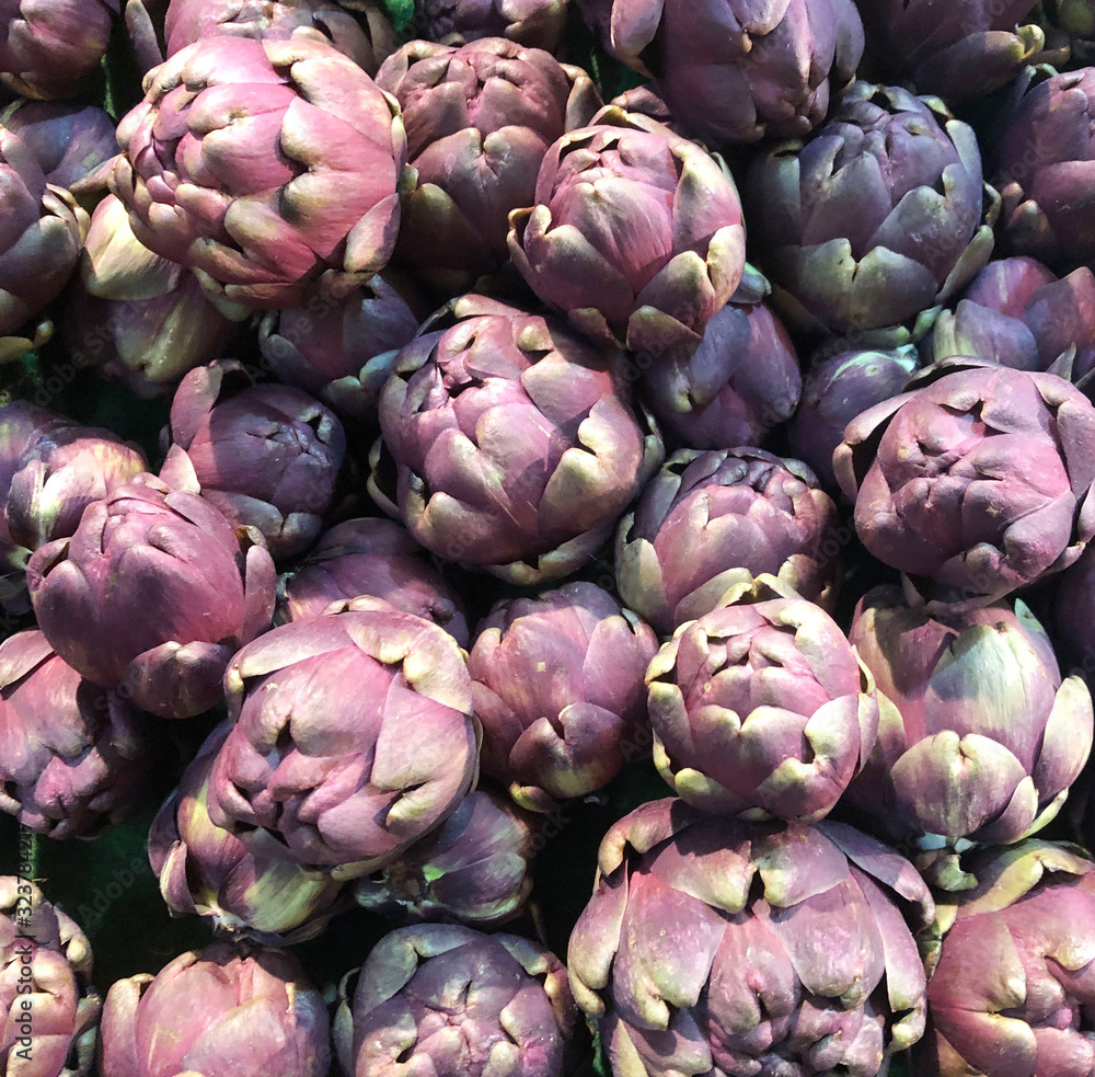Fototapeta premium Fresh, organic purple baby artichokes at Market.