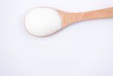 Brown sugar in a wooden spoon on a white background, healthy sugar. Used for cooking or desserts.
