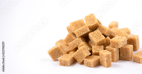 Brown sugar on a white background, healthy sugar used for cooking or desserts.